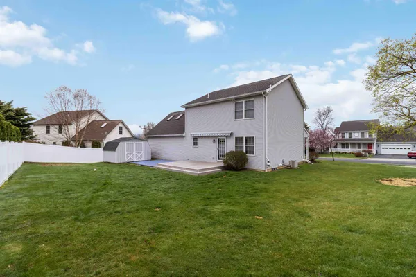 a view of a house with a backyard
