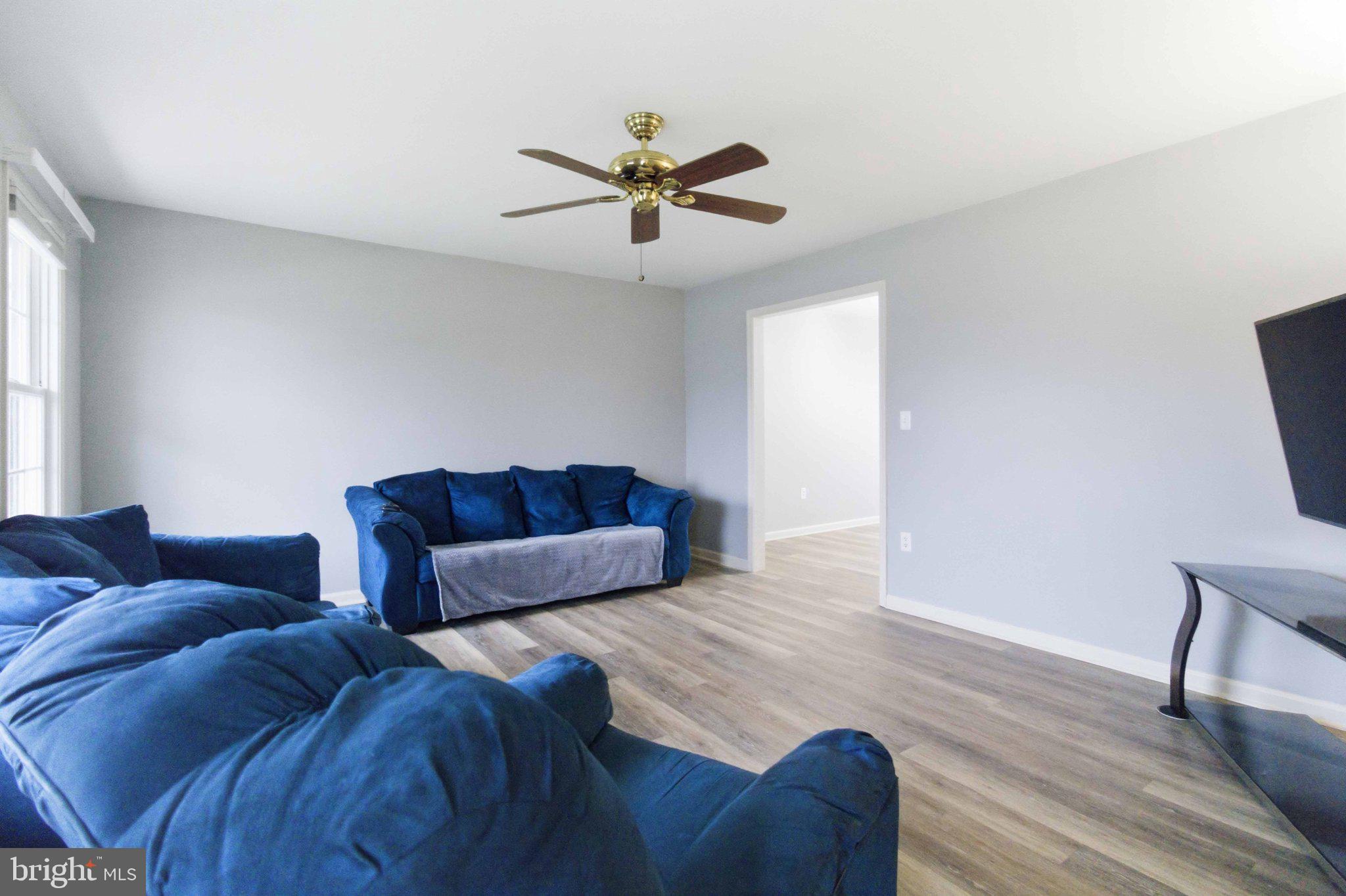 4 Grouse Road Dillsburg, PA 17019 - Photo 8 of 40 a living room with a couch and a ceiling fan