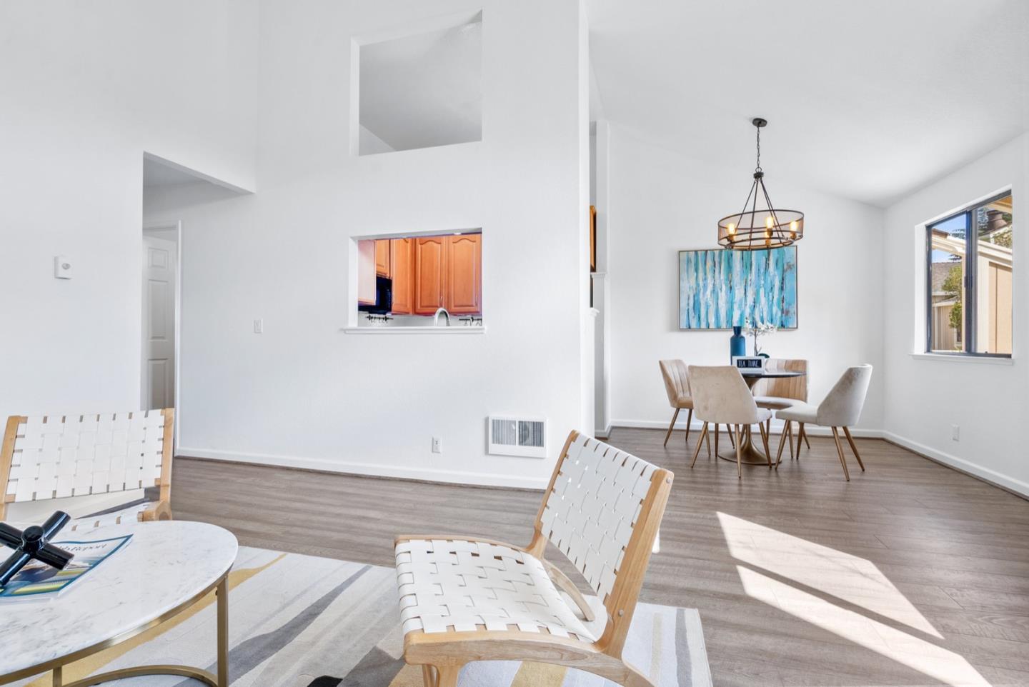2863 South Bascom Avenue, Unit 804 Campbell, CA 95008 - Photo 6 of 28 a living room with furniture a dining table and a chandelier