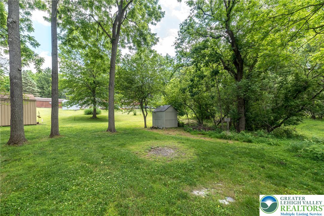 1815 Leithsville Road Hellertown, PA 18055 - Photo 37 of 38 A spacious, verdant yard with mature trees and a functional shed.