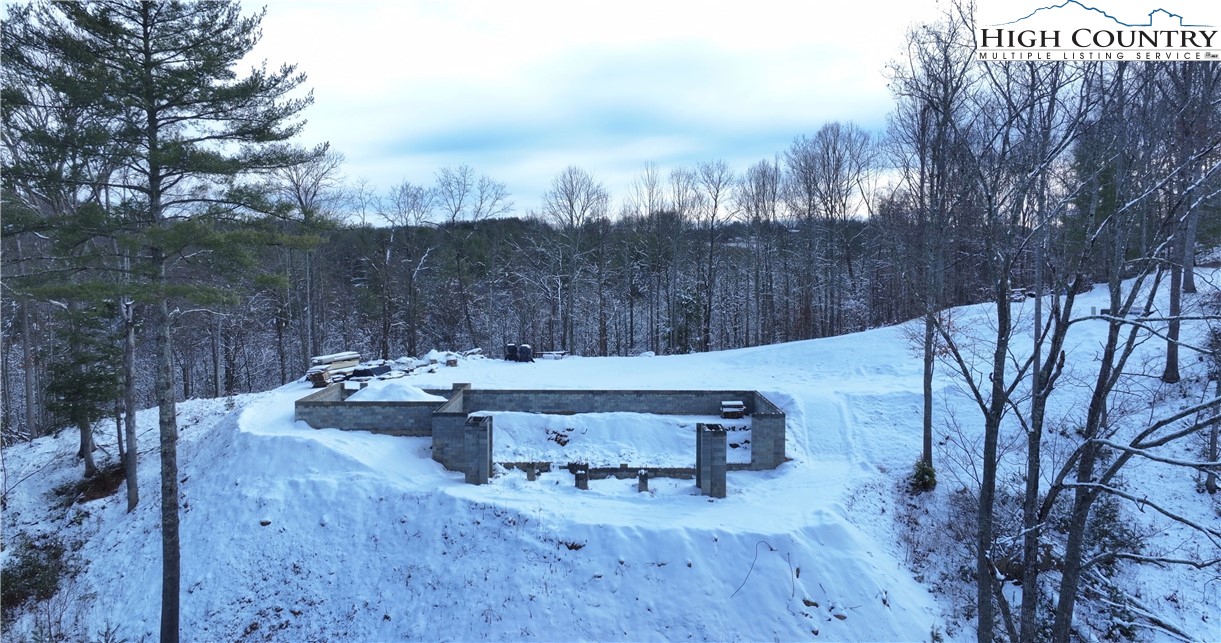 485 Autumn Leaf Way Crumpler, NC 28617 - Photo 16 of 40 a view of a terrace with a bench and trees