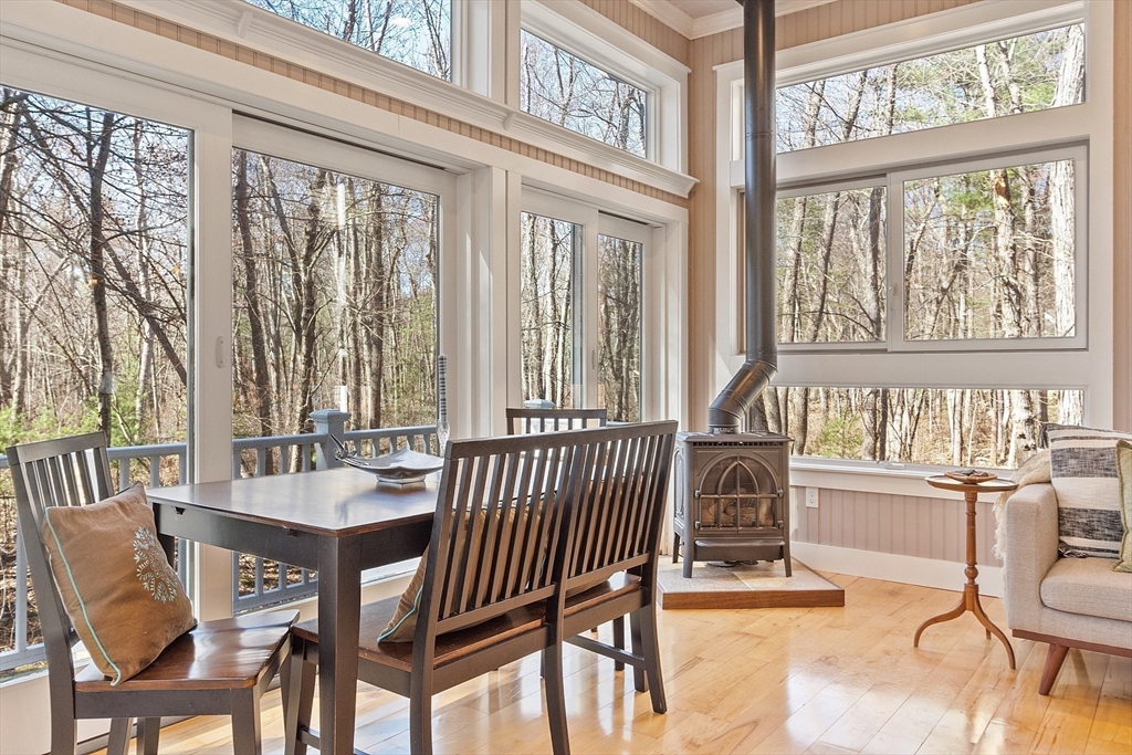 142 Pope Road Acton, MA 01720 - Photo 11 of 42 a view of a dining room with furniture a chandelier and wooden floor