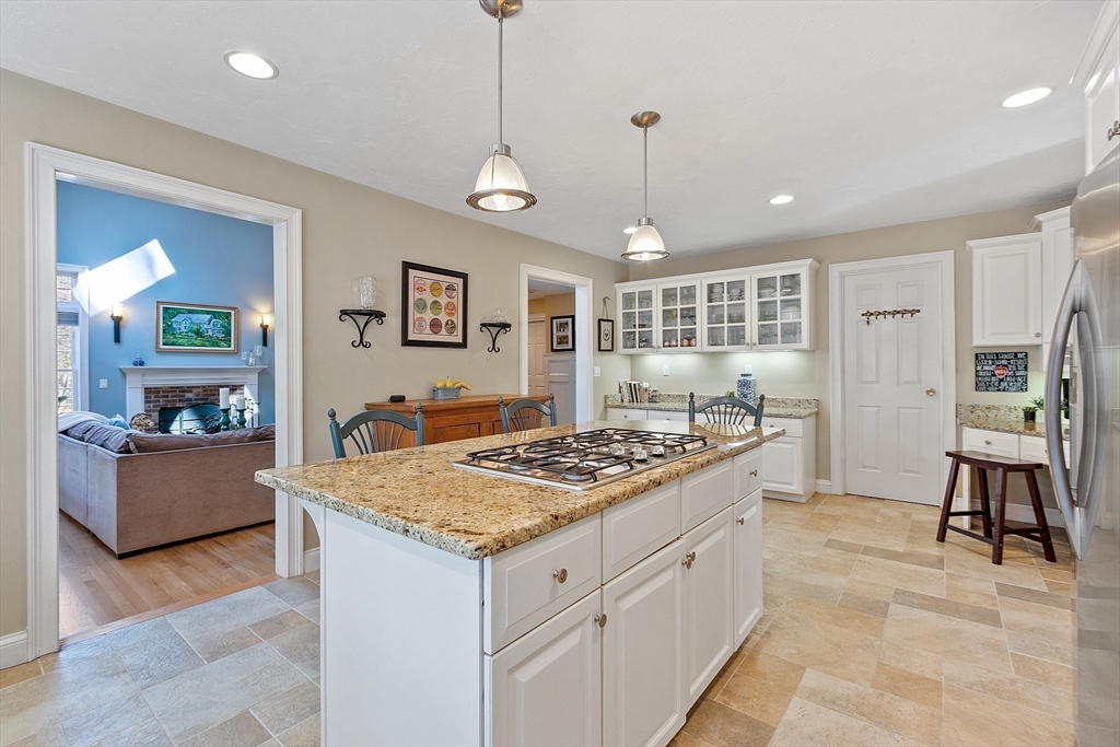 142 Pope Road Acton, MA 01720 - Photo 15 of 42 a kitchen with stainless steel appliances granite countertop white cabinets stove and refrigerator