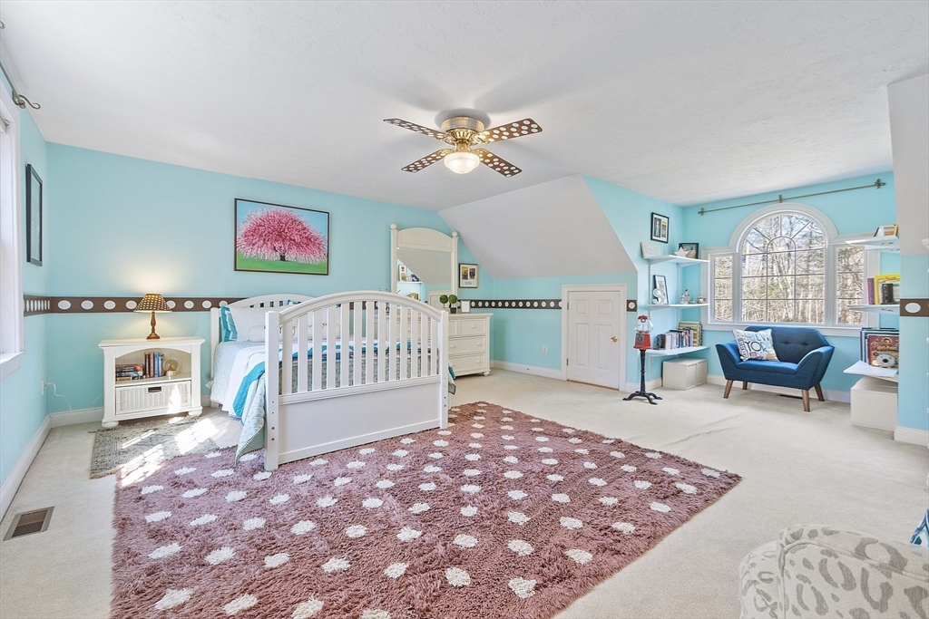 142 Pope Road Acton, MA 01720 - Photo 29 of 42 a bedroom with furniture and a rug