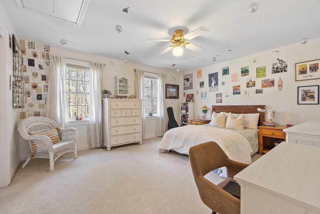 142 Pope Road Acton, MA 01720 - Photo 30 of 42 a spacious bedroom with a bed and a chair