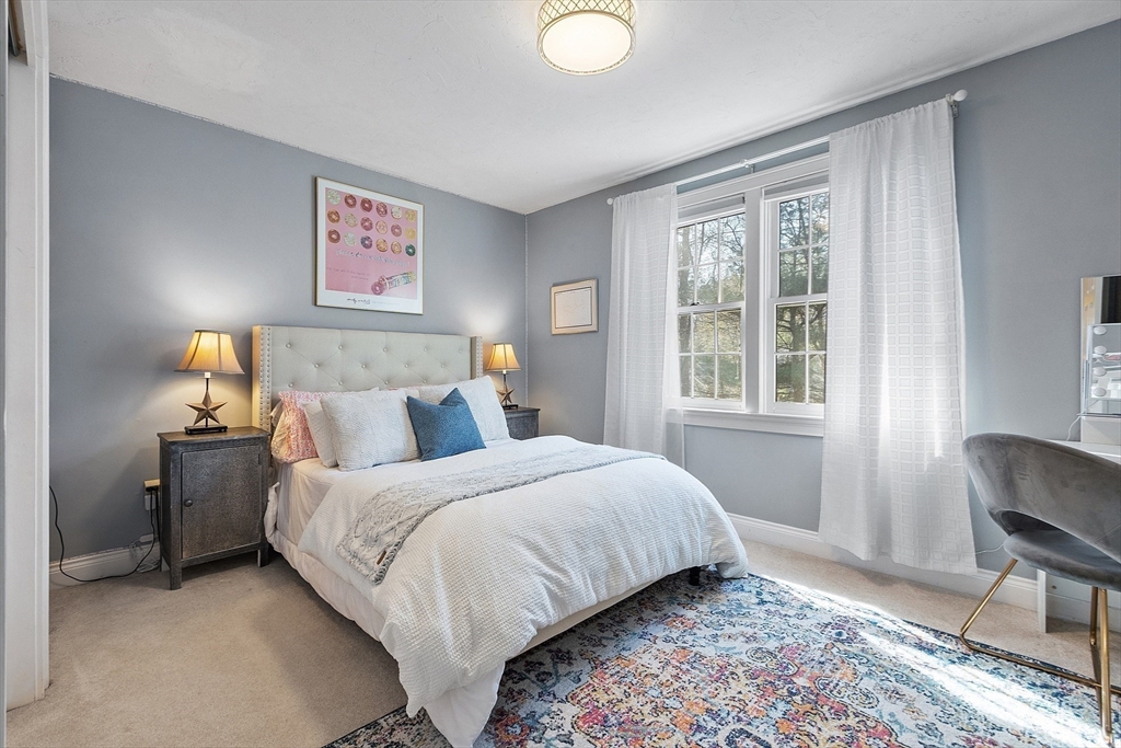 142 Pope Road Acton, MA 01720 - Photo 31 of 42 a bedroom with a bed and wooden floor