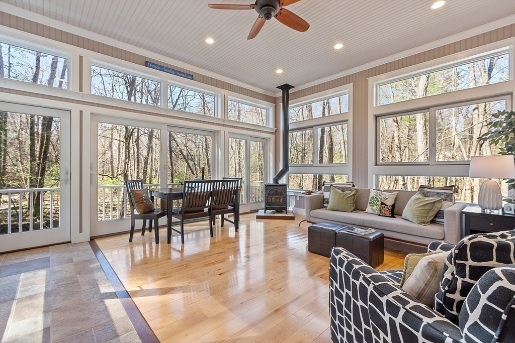 142 Pope Road Acton, MA 01720 - Photo 9 of 42 a dining room with furniture a large window and a rug