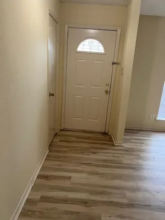 a view of a room with wooden floor and staircase