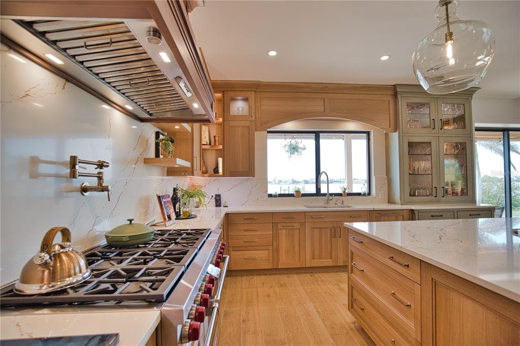 1819 Chadwick Road Englewood, FL 34223 - Photo 27 of 90 a kitchen with kitchen island granite countertop a stove and a sink