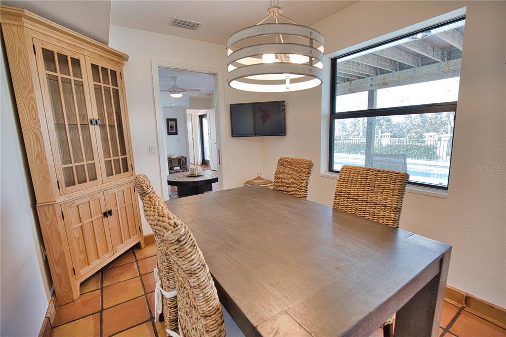 1819 Chadwick Road Englewood, FL 34223 - Photo 64 of 90 a view of a dining room with furniture wooden floor and chandelier