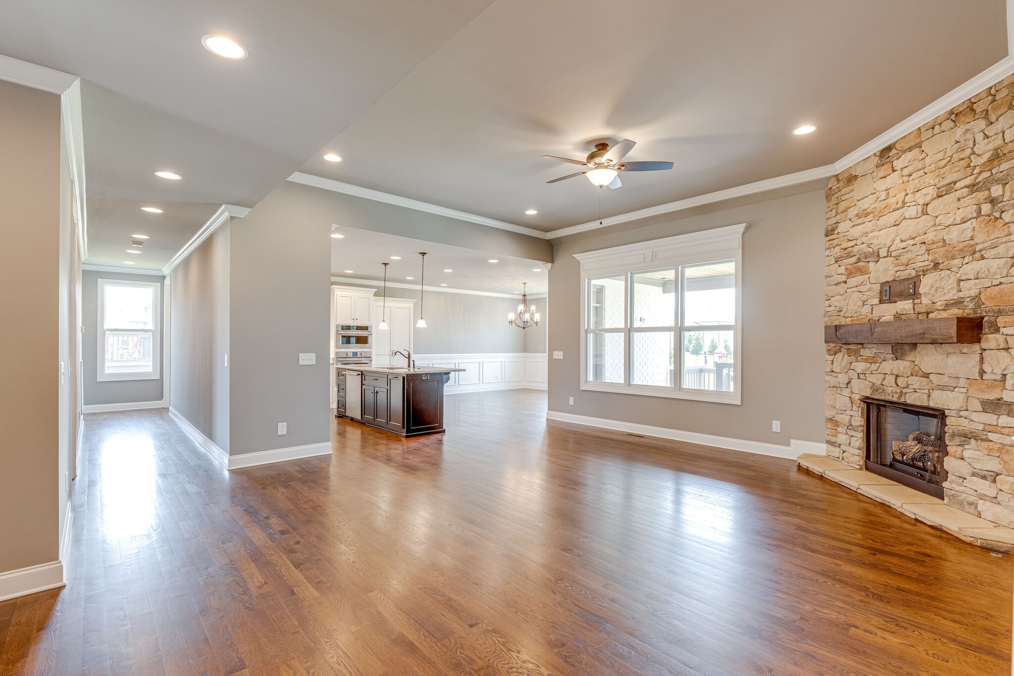 1029 Abbey Rd Way Spring Hill, TN 37174 - Photo 12 of 51 a view of a big room with wooden floor and a kitchen
