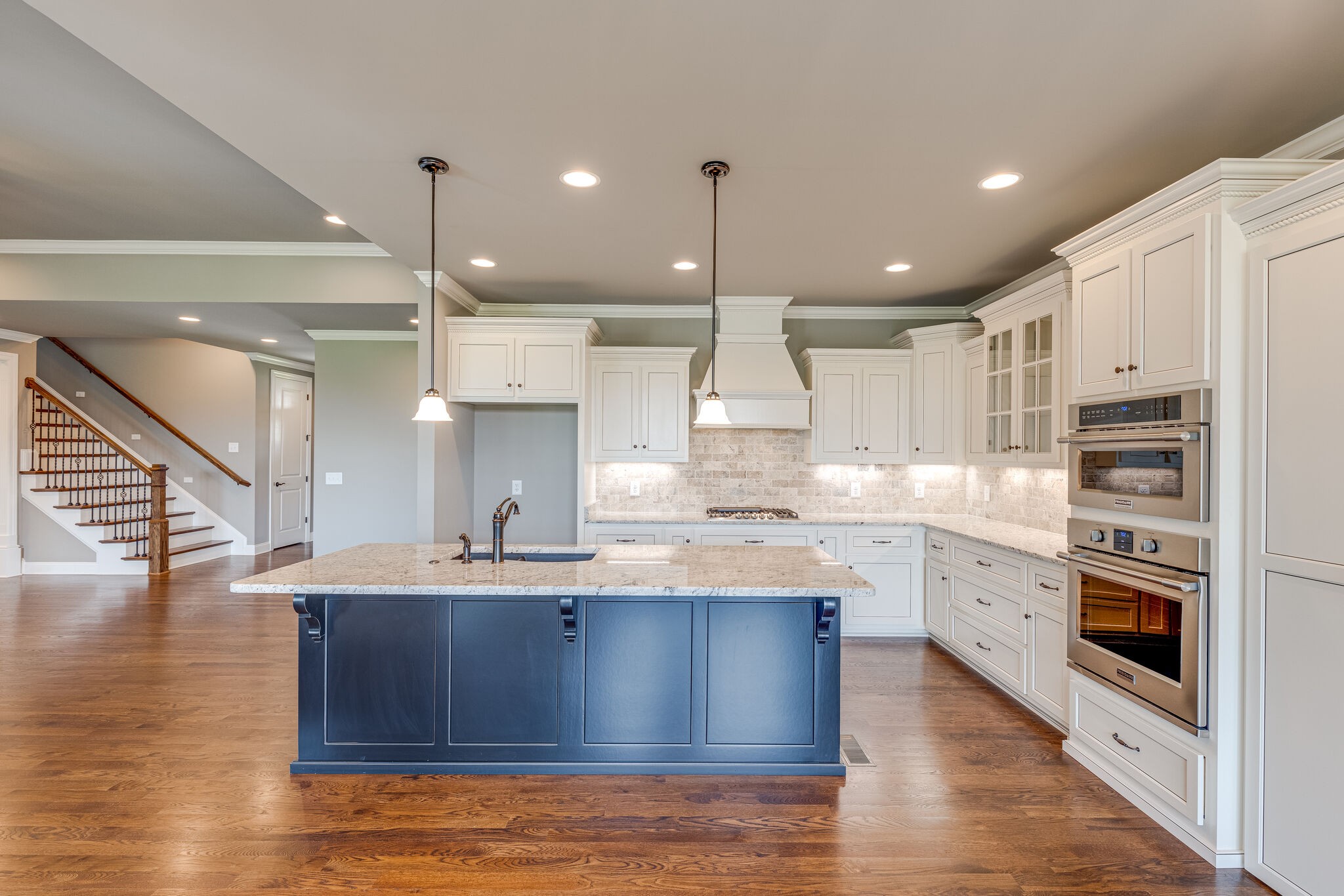 1029 Abbey Rd Way Spring Hill, TN 37174 - Photo 13 of 51 a kitchen with stainless steel appliances granite countertop a sink a stove and a wooden floors