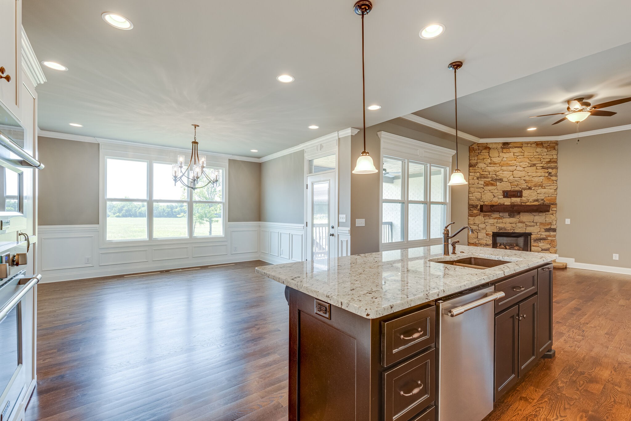 1029 Abbey Rd Way Spring Hill, TN 37174 - Photo 17 of 51 a kitchen with kitchen island granite countertop a stove a sink a center island and wooden floor