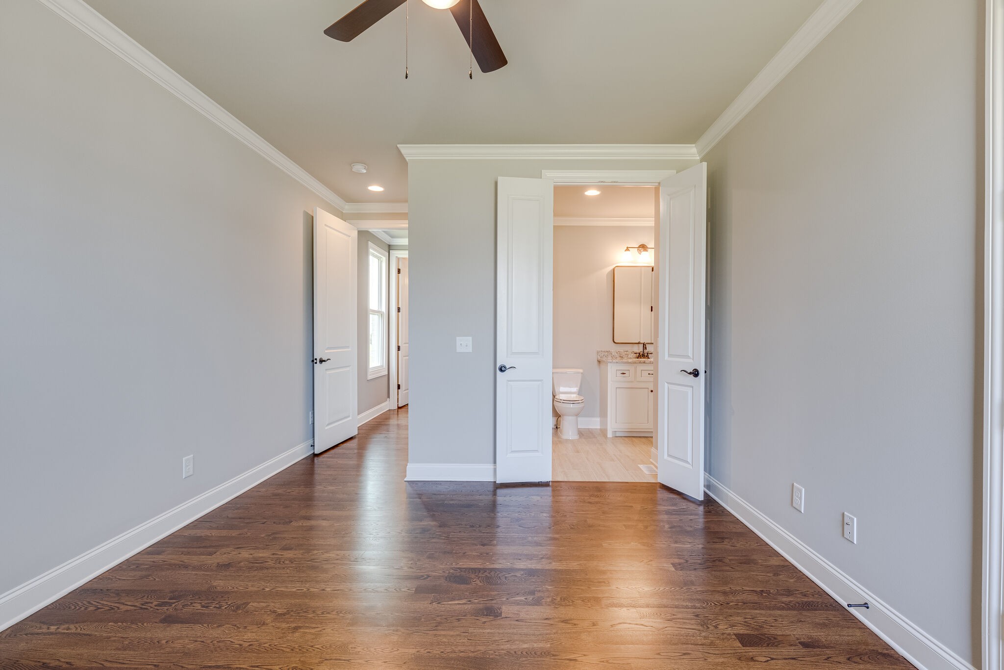 1029 Abbey Rd Way Spring Hill, TN 37174 - Photo 26 of 51 a view of an empty room with wooden floor and a ceiling fan