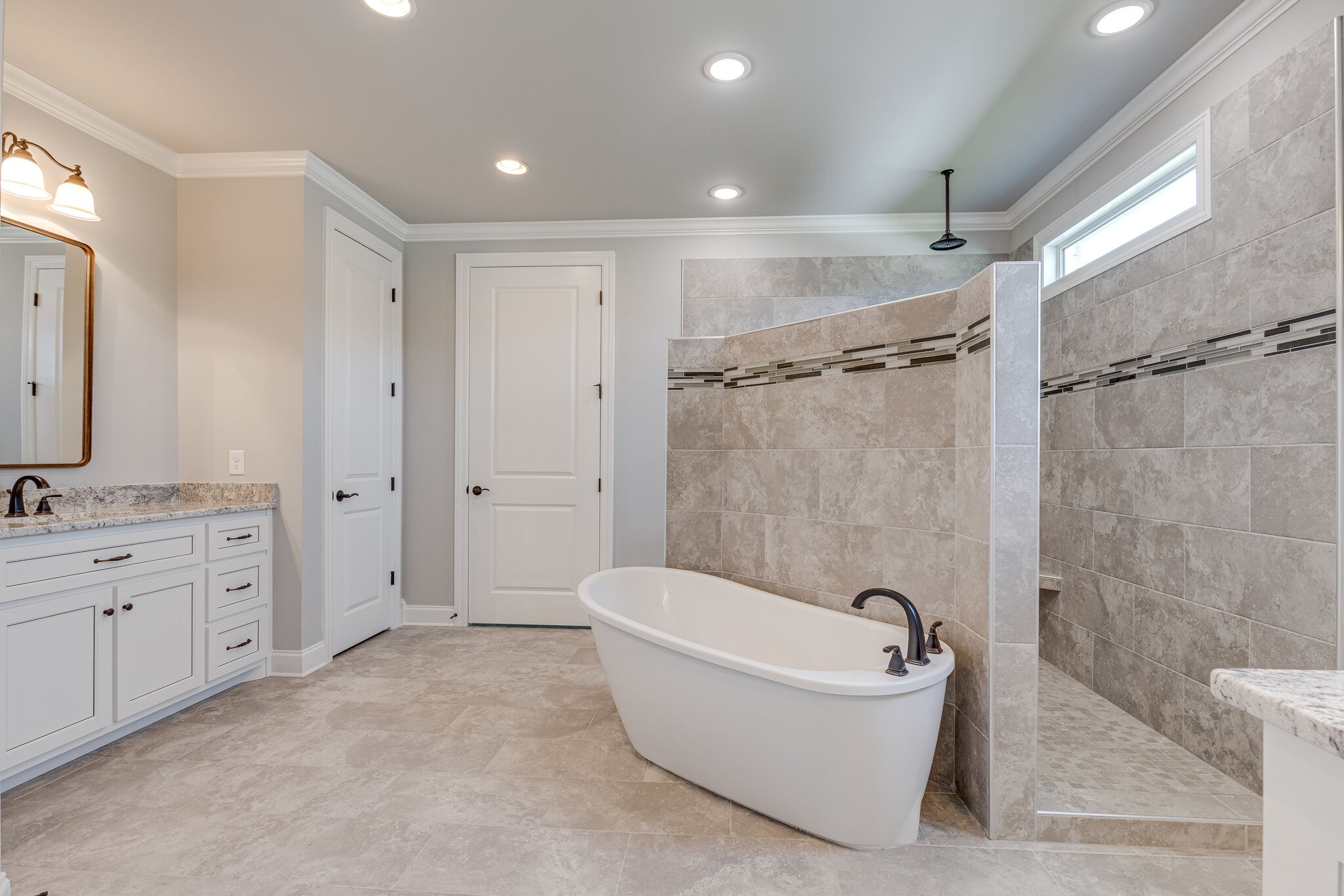 1029 Abbey Rd Way Spring Hill, TN 37174 - Photo 30 of 51 a spacious bathroom with a tub shower a mirror and a sink
