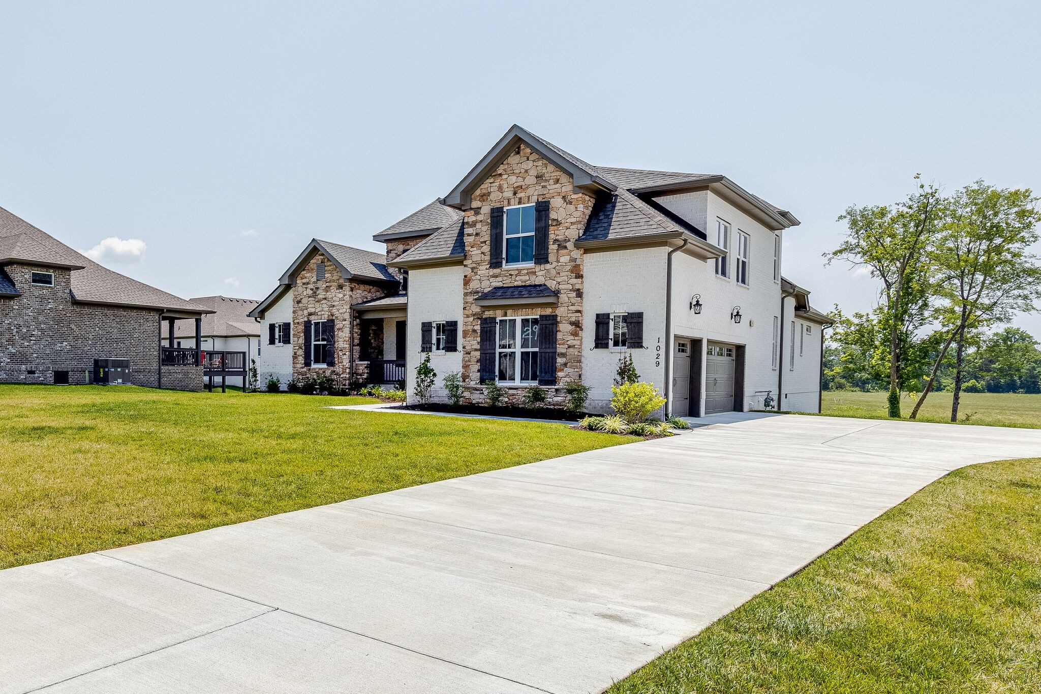 1029 Abbey Rd Way Spring Hill, TN 37174 - Photo 4 of 51 a front view of a house with a yard and trees