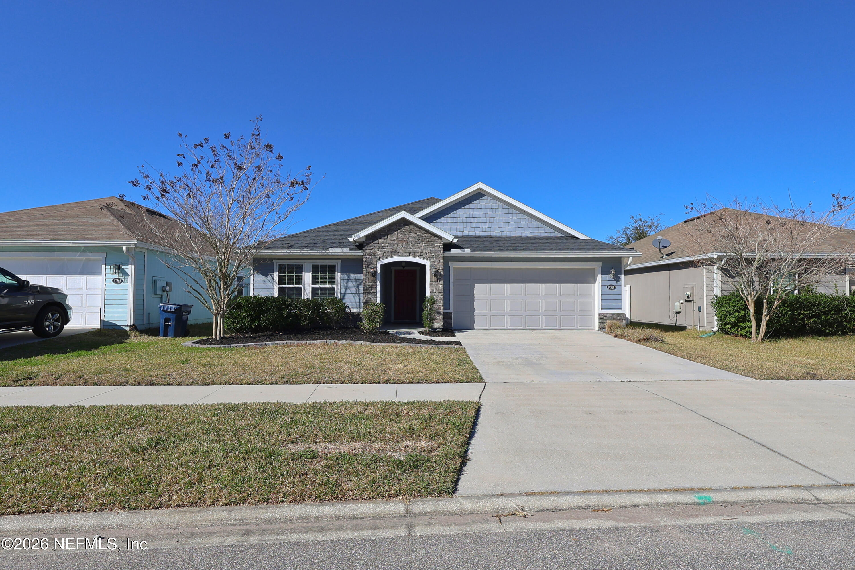 97569 Albatross Drive Yulee, FL 32097 - Photo 2 of 41 a front view of a house with a yard and garage