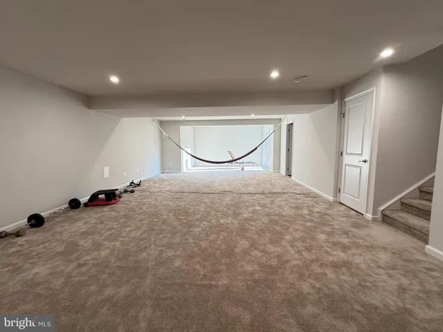 a view of a room with gym equipment and white walls