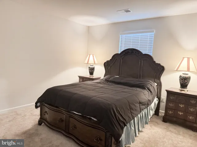 a bedroom with a bed and a fireplace