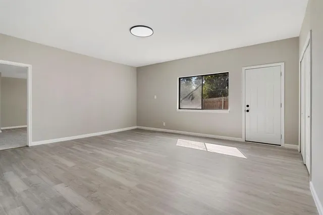 an empty room with windows and closet