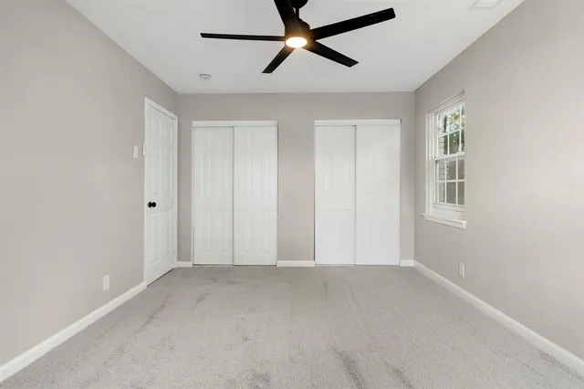 a view of room with hardwood floor and ceiling fan