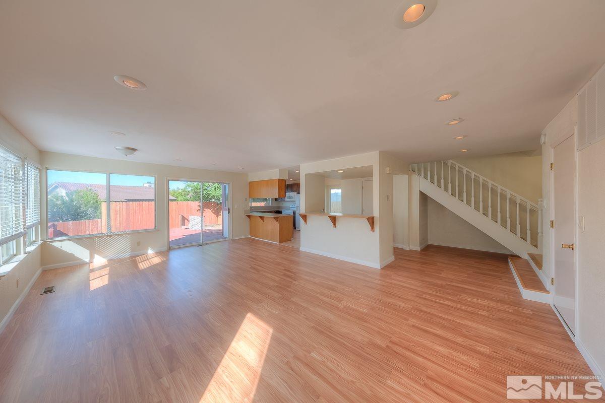 6865 Forsythia Way Reno, NV 89506 - Photo 4 of 39 a view of empty room with wooden floor