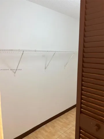 an empty room with a chandelier fan