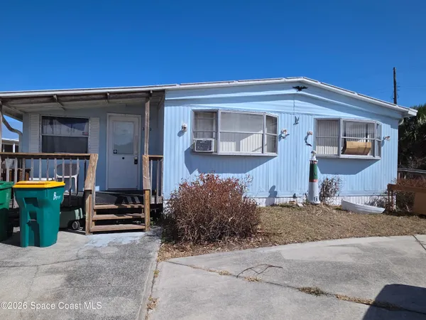a front view of a house with parking space