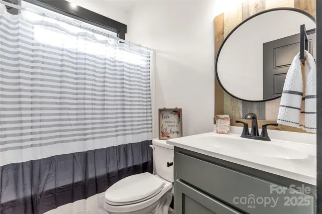 a bathroom with a sink a toilet and mirror