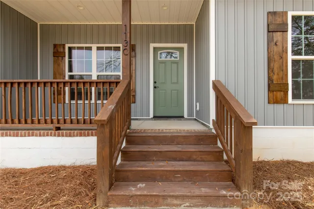 a view of entryway with wooden floor and a front door