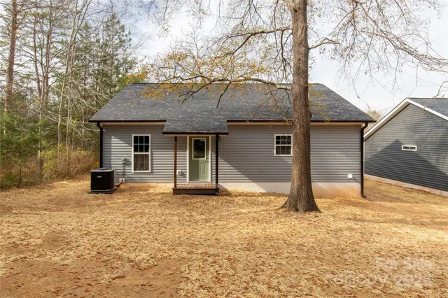 a house that has a tree in front of it