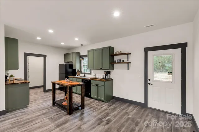 a view of a workspace with furniture and wooden floor
