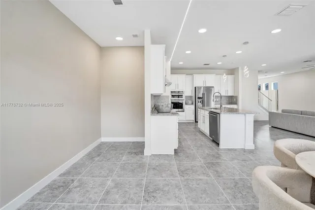 a bathroom with a granite countertop sink a toilet and shower