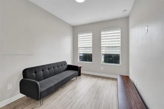 a living room with furniture and stairs