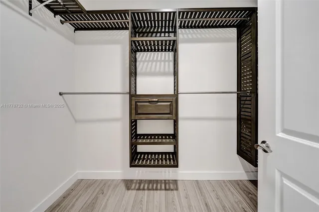 a view of a backyard with couches under an umbrella