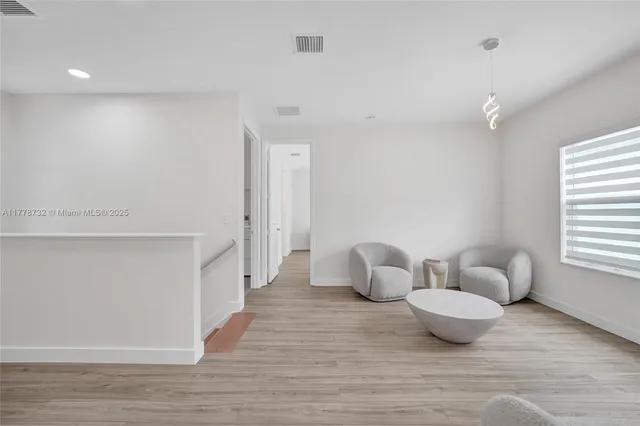 a view of swimming pool with outdoor seating and plants