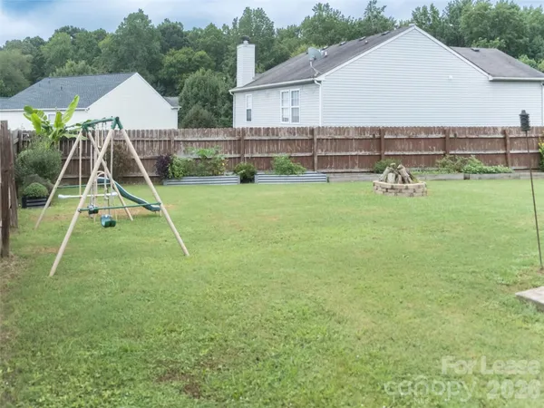 a view of a backyard with table and chairs