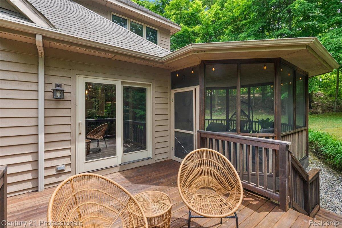 9867 Rainbow Ridge Drive Schoolcraft, MI 49087 - Photo 61 of 82 Expansive wood deck with a screened-in porch, featuring a wood railing and exterior lighting fixtures