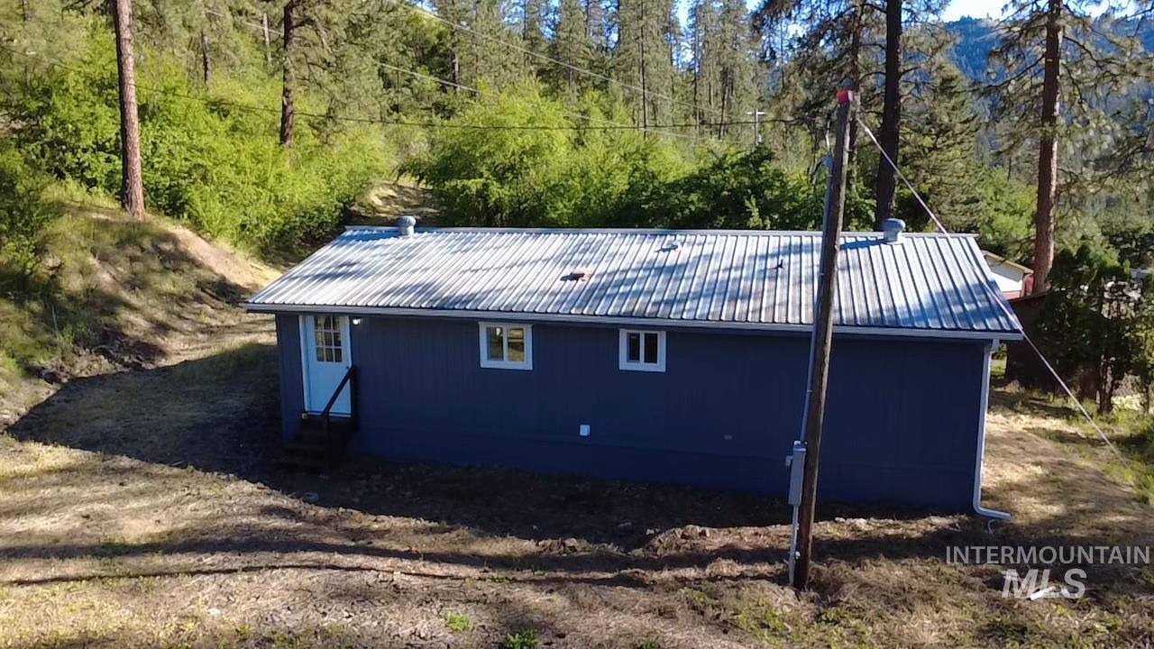 151 View Road Kamiah, ID 83536 - Photo 41 of 49 Blue siding exterior with a corrugated metal roof