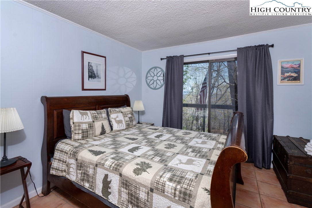 103 Mid Holiday Lane, Unit 115D Beech Mountain, NC 28604 - Photo 13 of 25 a bedroom with a bed and a window