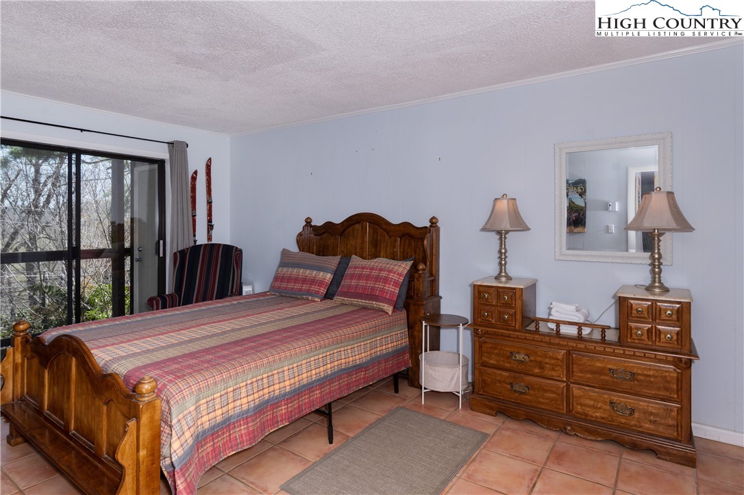 103 Mid Holiday Lane, Unit 115D Beech Mountain, NC 28604 - Photo 14 of 25 a bedroom with a bed and large window