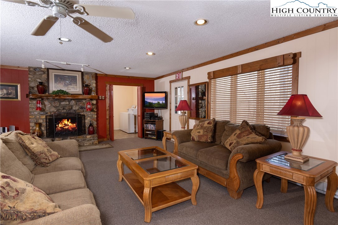 103 Mid Holiday Lane, Unit 115D Beech Mountain, NC 28604 - Photo 25 of 25 a living room with furniture a flat screen tv and a fireplace