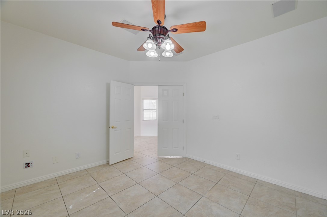 8918 Houston Ridge Avenue Las Vegas, NV 89178 - Photo 32 of 35 A versatile room with durable tile flooring, perfect for a home office or creative space.
