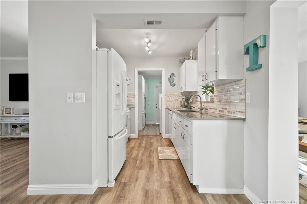 2602 Southeast Jackson Street Stuart, FL 34997 - Photo 15 of 53 a view of a hallway with wooden floor and a living room
