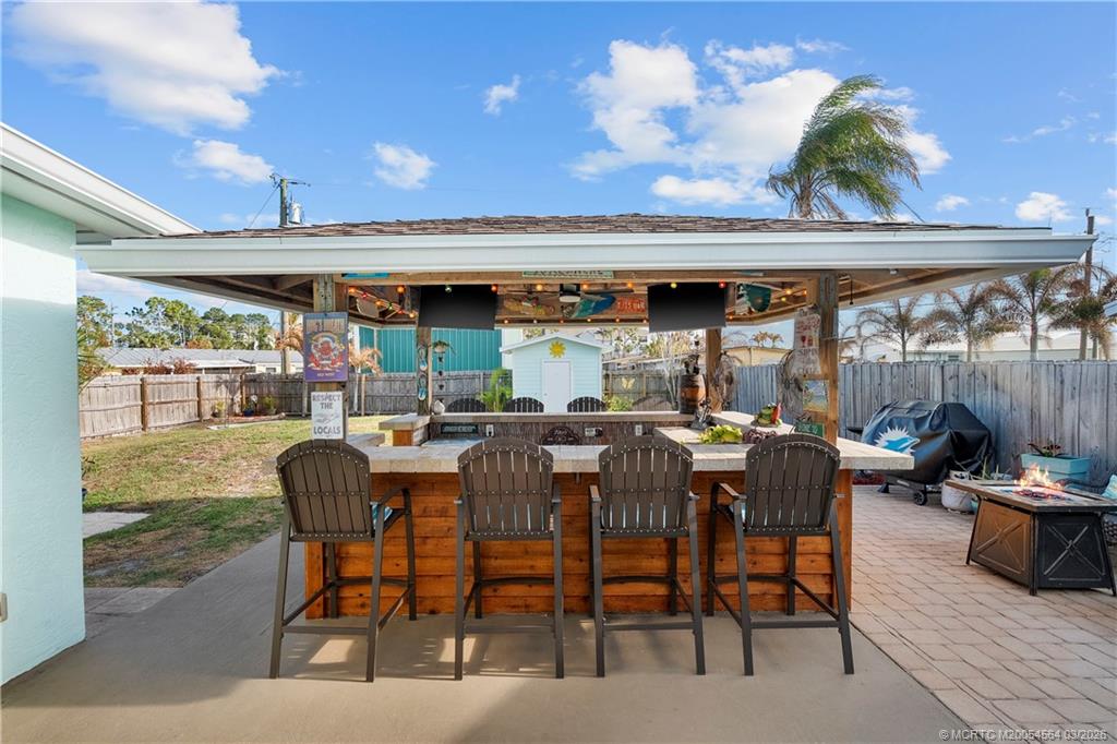 2602 Southeast Jackson Street Stuart, FL 34997 - Photo 30 of 53 a view of a patio with table and chairs