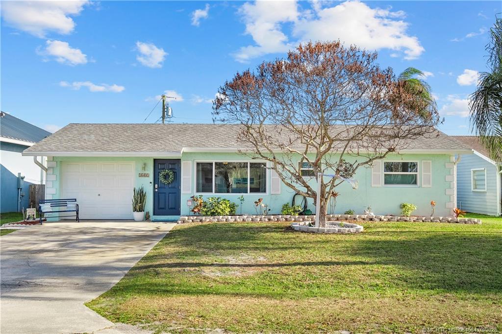 2602 Southeast Jackson Street Stuart, FL 34997 - Photo 3 of 53 a front view of house with yard and green space