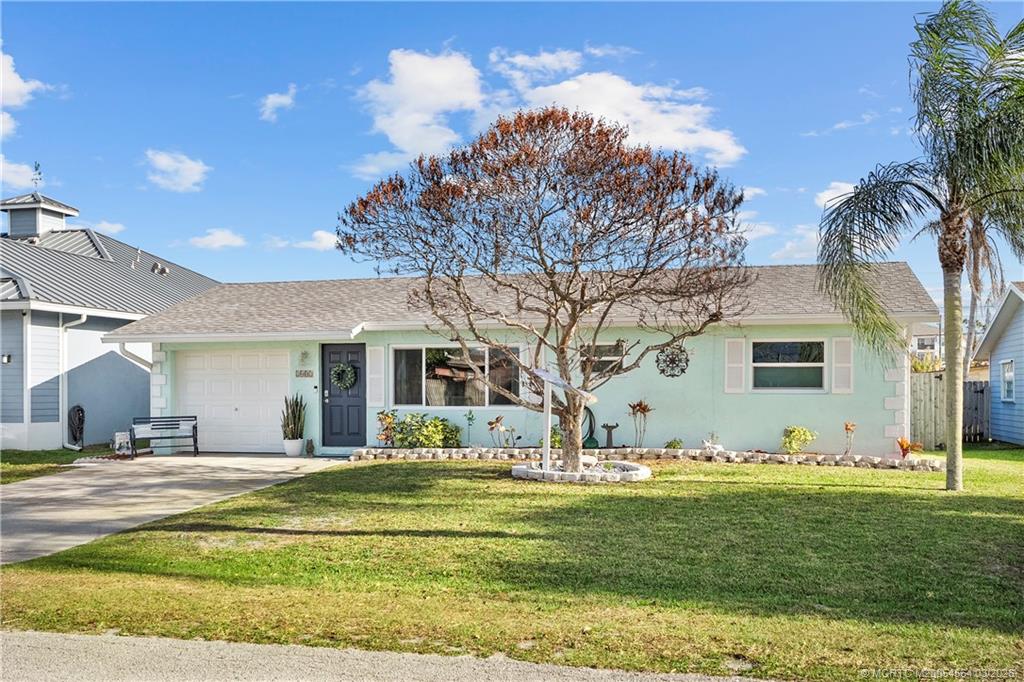 2602 Southeast Jackson Street Stuart, FL 34997 - Photo 8 of 53 a view of a house with a yard