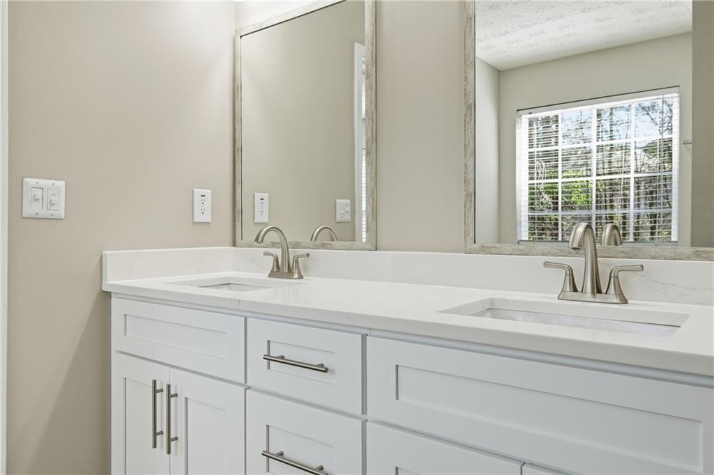 3570 Bogan Mill Road Northeast Buford, GA 30519 - Photo 19 of 31 a bathroom with a sink and a mirror