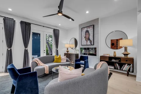 a living room with furniture and a baby crib
