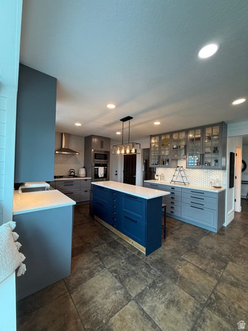 965 North 800 East Springville, UT 84663 - Photo 15 of 46 Kitchen featuring backsplash, glass insert cabinets, gray cabinetry, and a kitchen island